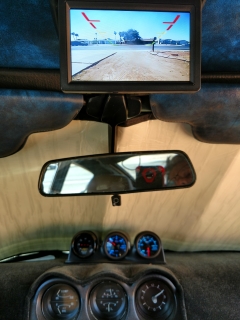 Monitor flipped down showing Rear backup camera, doubles as a front facing camera in forward gears. You can see it was intended by the mfg to be dash and not roof mounted. It still works pretty well.